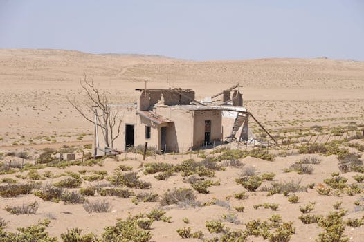 A decaying building in the arid landscape of Kolmanskop, Karas Region, Namibia.