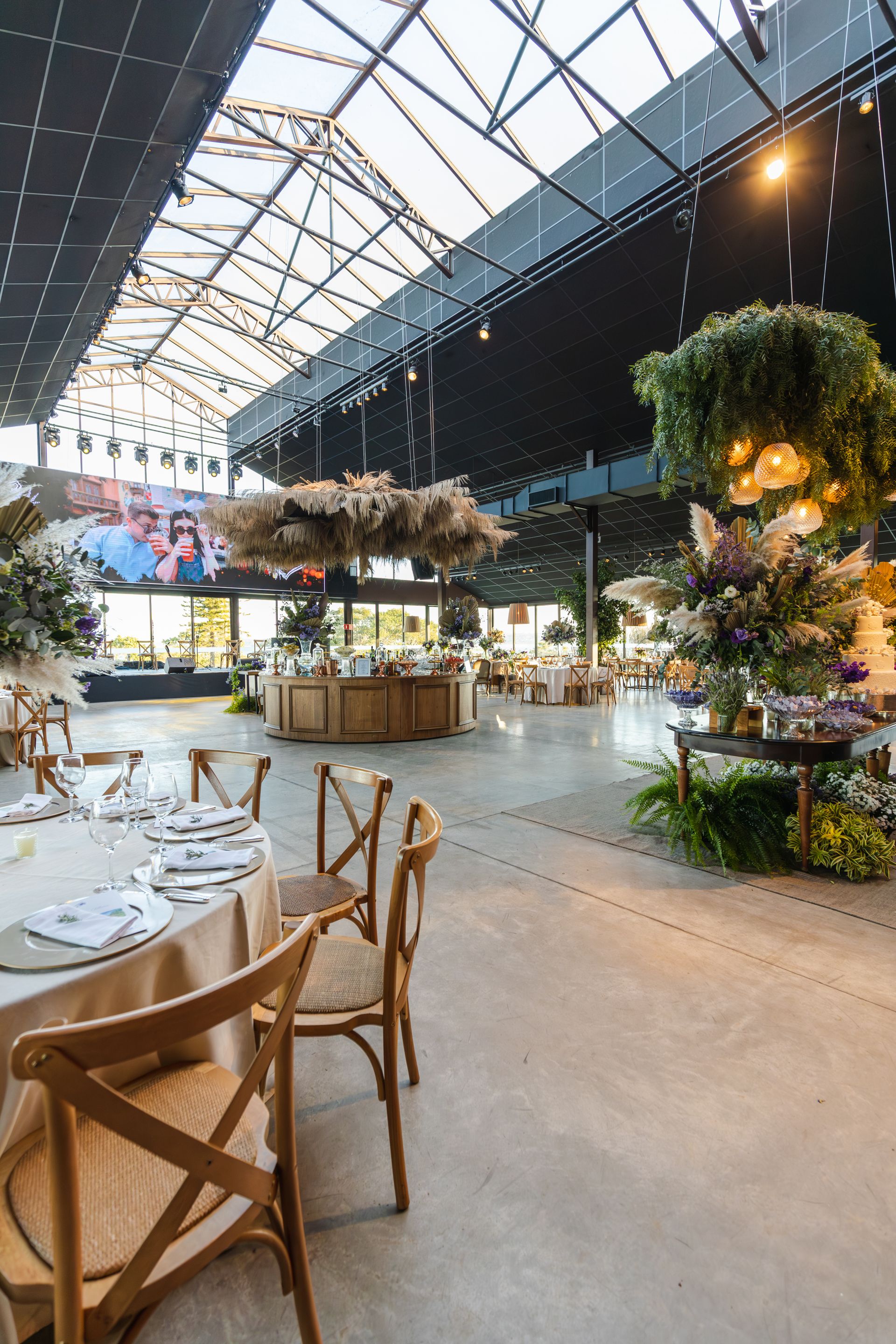 Spacious venue elegantly decorated with hanging florals