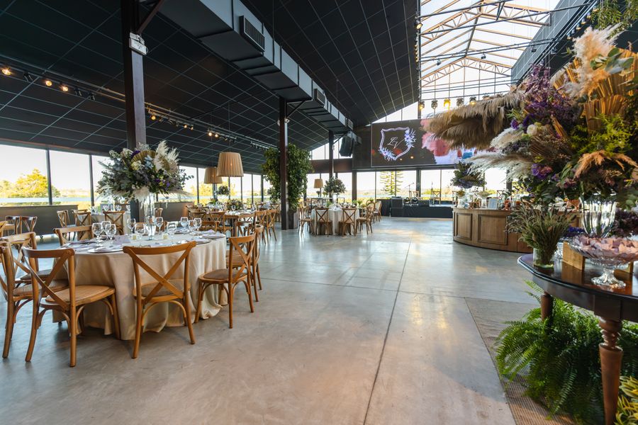 Spacious wedding reception venue with elegant floral decor