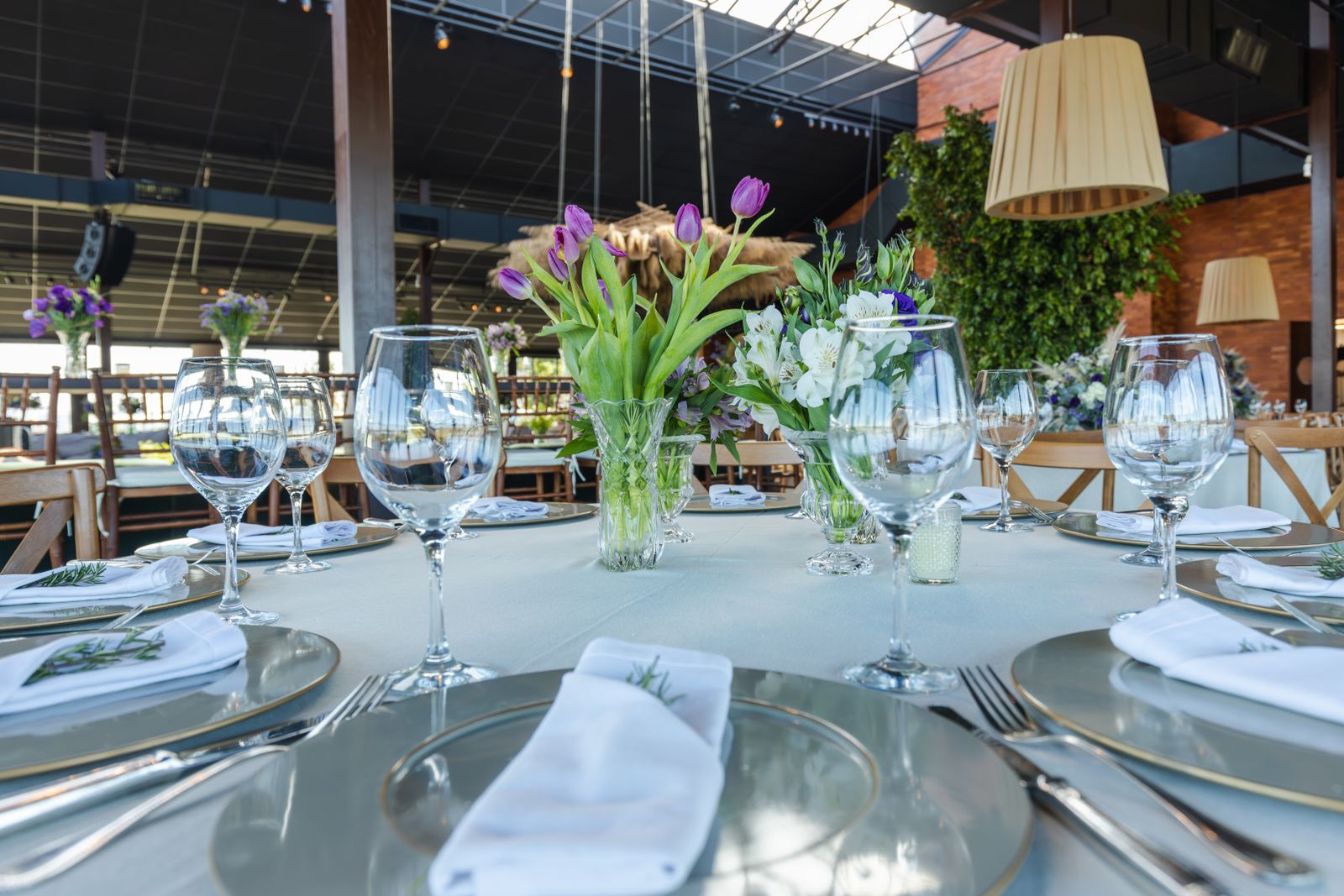 Wedding reception table with glassware and floral centerpiece