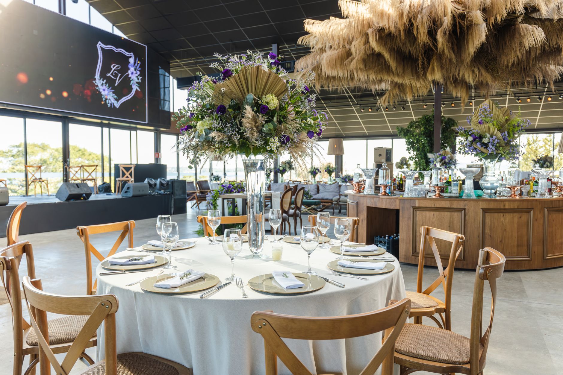 Luxurious wedding reception setting with beautifully arranged floral centerpieces and elegant table settings.