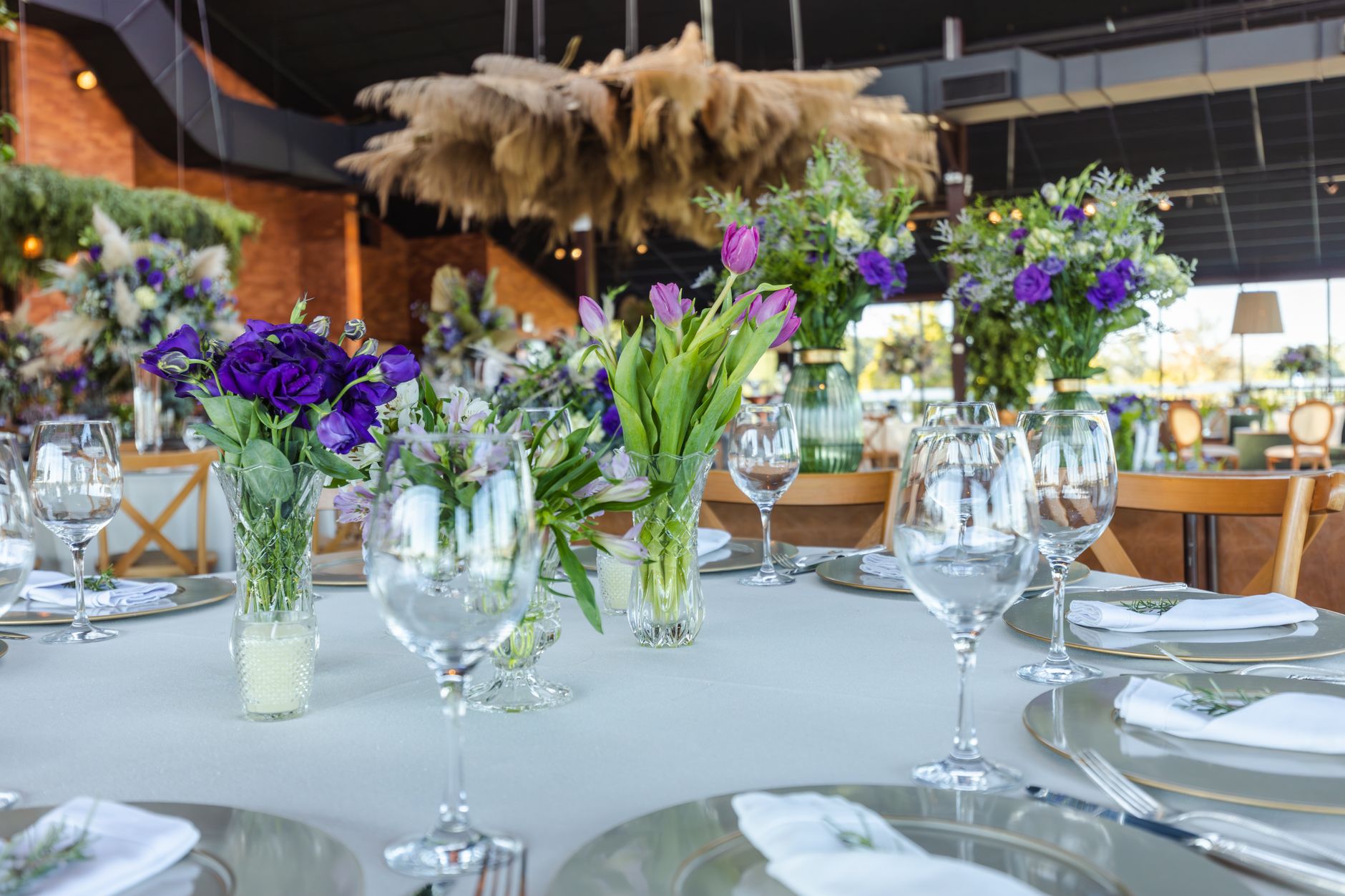 A beautifully decorated wedding table with elegant floral centerpieces and fine glassware.