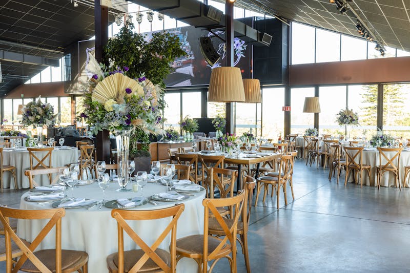 Elegant banquet hall with warm lighting and table settings