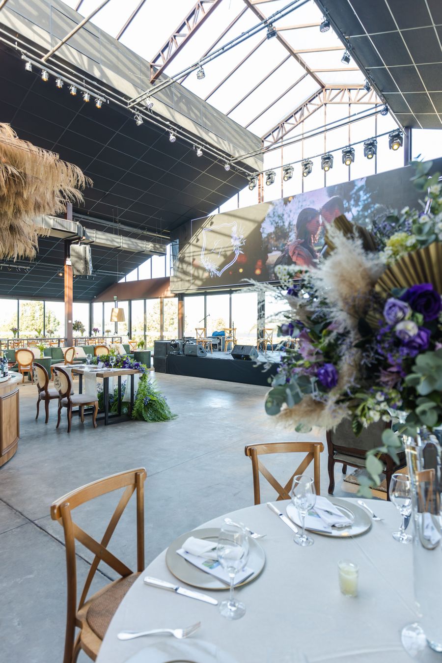 Spacious wedding reception hall with elegant floral arrangements