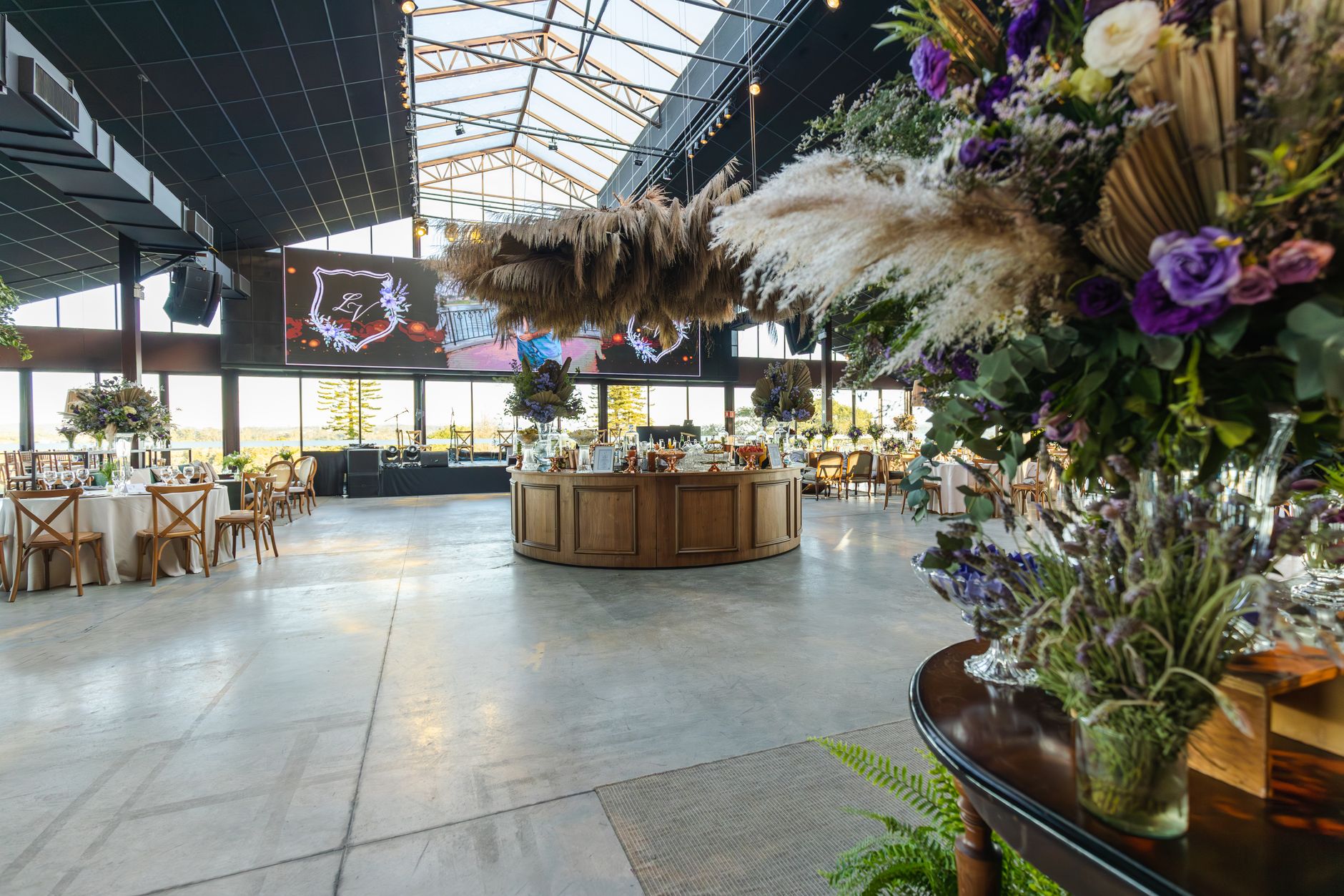 Beautifully decorated indoor venue with floral arrangements and ample space for events.
