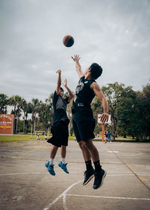 Free Dynamic outdoor basketball game with players in action under cloudy skies in Rioja, Peru. Stock Photo
