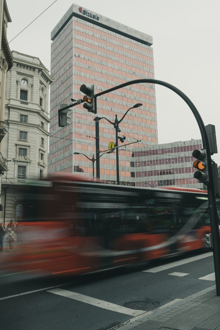 Red Bus Dashing On A City Street In Bilbao, Spain