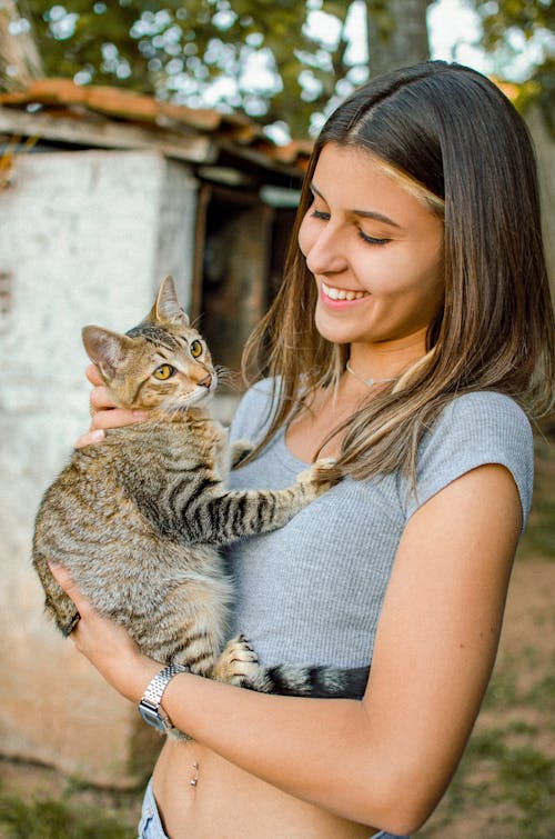 Woman Holding on Hand Kitten