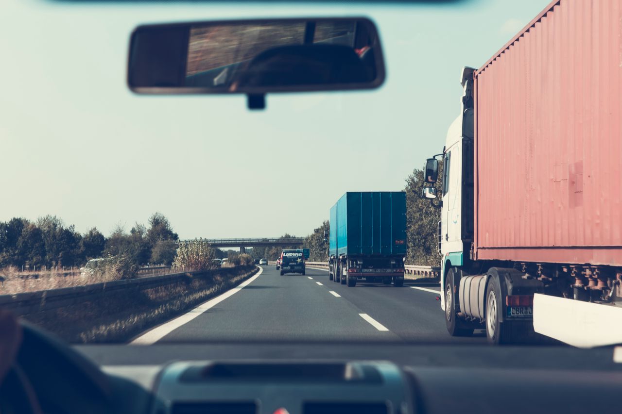 Lorries on a German motorway seen in a vehicle’s wing mirror