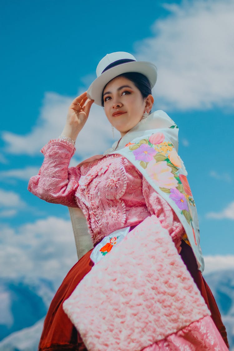 Low Angle View Of Woman In Pink Historical Costume Against Blue Sky