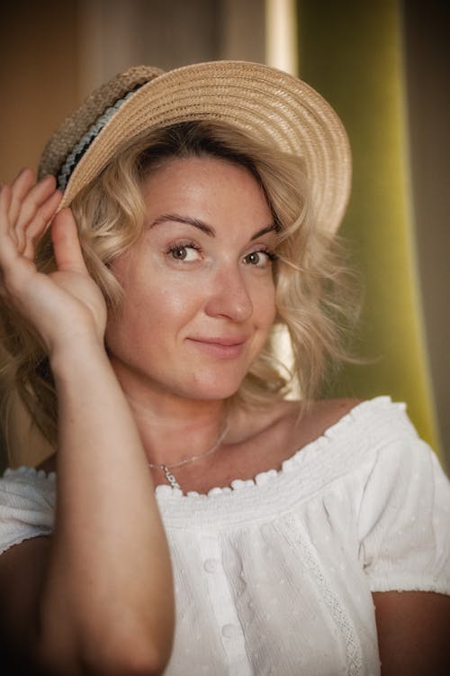 Portrait of Blonde Woman Wearing Straw Hat 