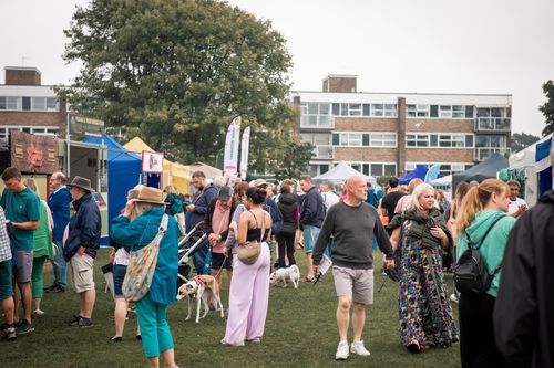 Free Community festival gathering with diverse people enjoying stalls in Highcliffe, UK. Stock Photo