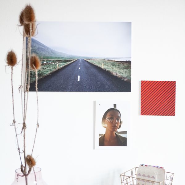 Framed landscape and portrait prints on a white wall — photo by Squared one on Pexels