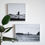 Framed black and white prints hung on a white wall, photo by Squared one on Pexels