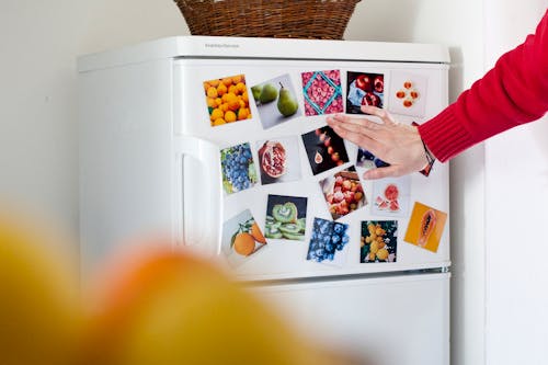 magnets with photos on a fridge