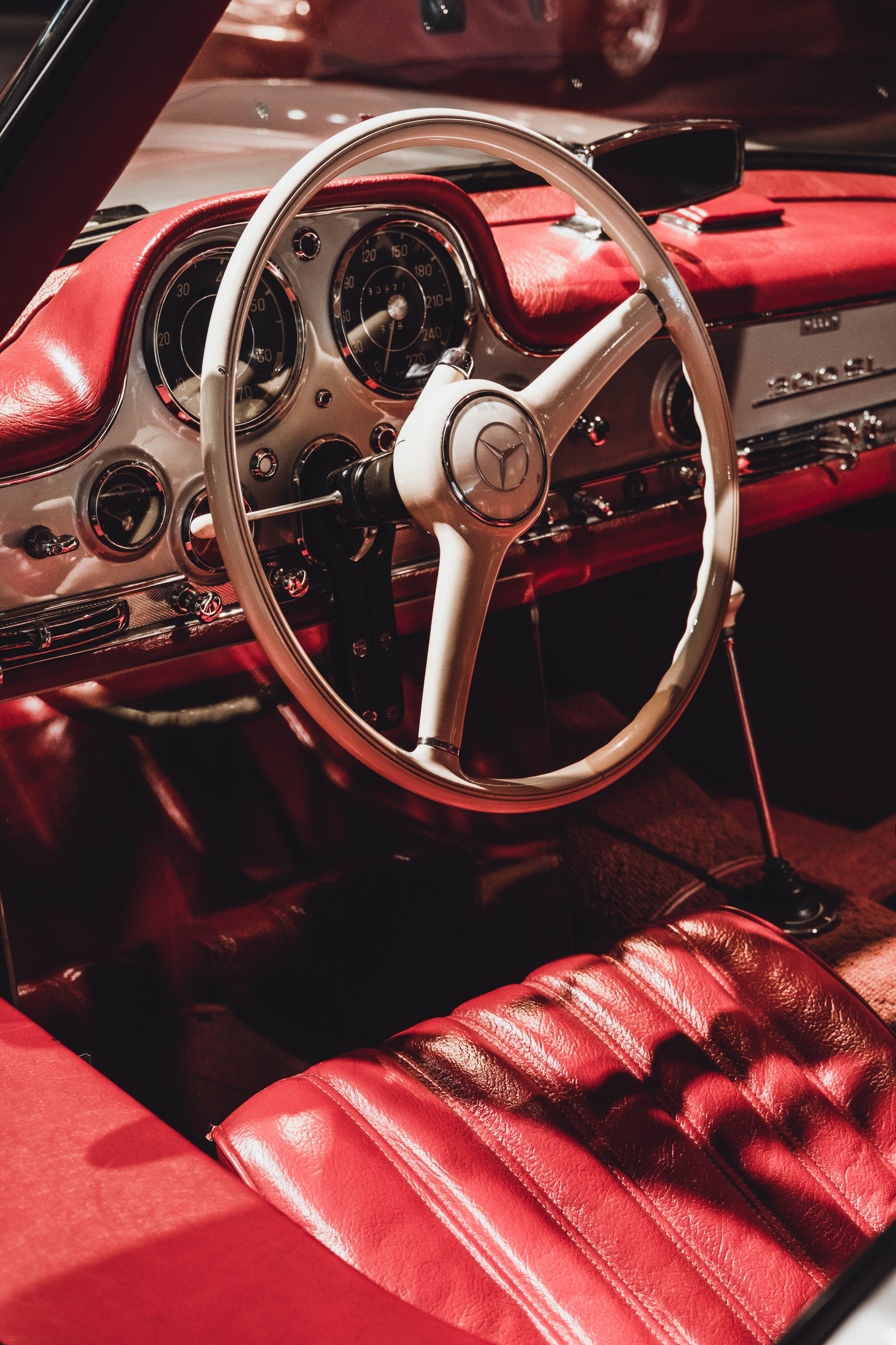A red and white interior of a classic car · Free Stock Photo
