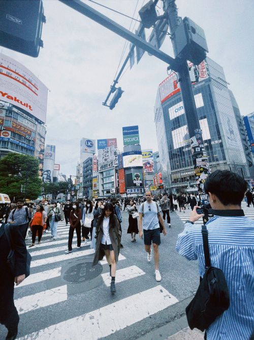 Free Vibrant street scene at Shibuya Crossing in Tokyo, full of pedestrians and city life. Stock Photo