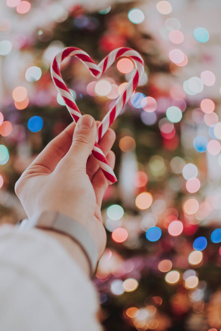 Photo Of Person Holding Heart Shaped Candy Cane