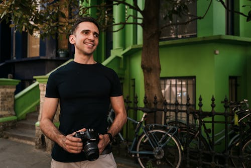 Smiling Man in T-shirt and with Camera