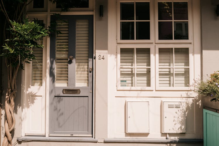 Facade Of White Building With Doors Painted Grey