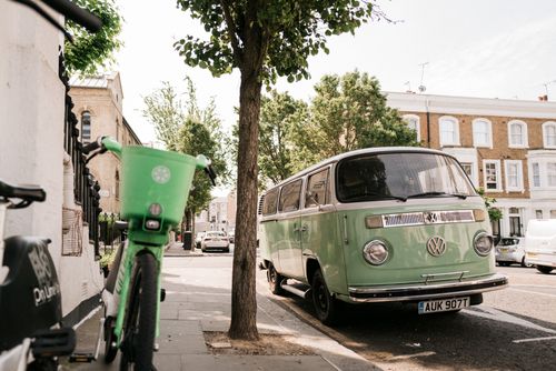 Free A vintage green Volkswagen van parked on a sunny London street, capturing urban charm. Stock Photo