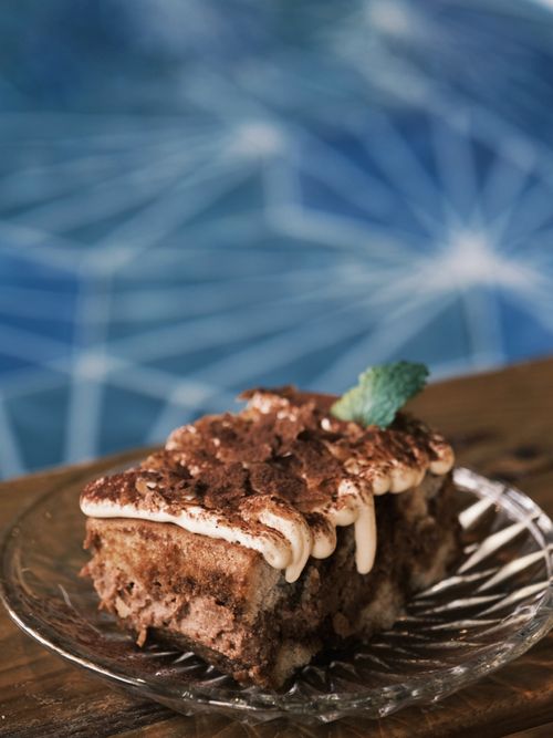 Free Close-up of a rich chocolate tiramisu dessert on a glass plate, perfect for sweet indulgence. Stock Photo