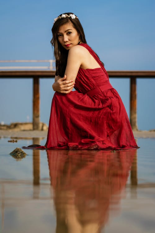 Woman Kneeling Near Fence