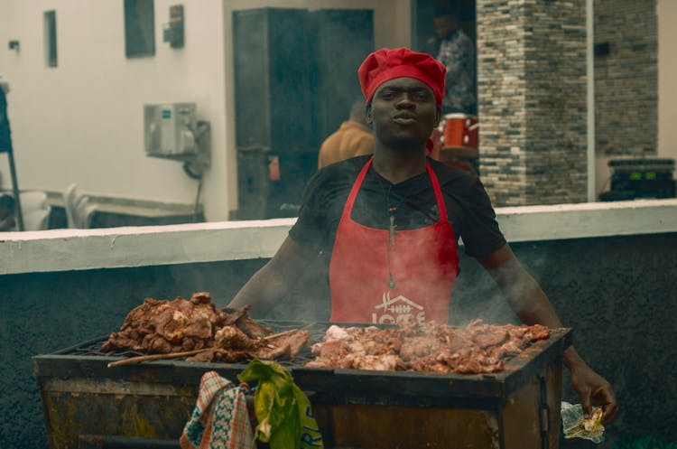 Man Roasting Meat In A Restaurant