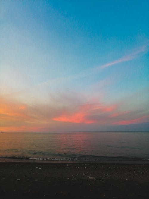 Free Beach and Sea under a Dramatic Sky  Stock Photo