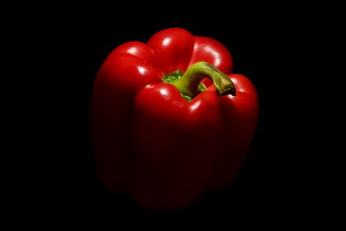 Free A striking close-up of a red bell pepper on a black studio backdrop. Stock Photo