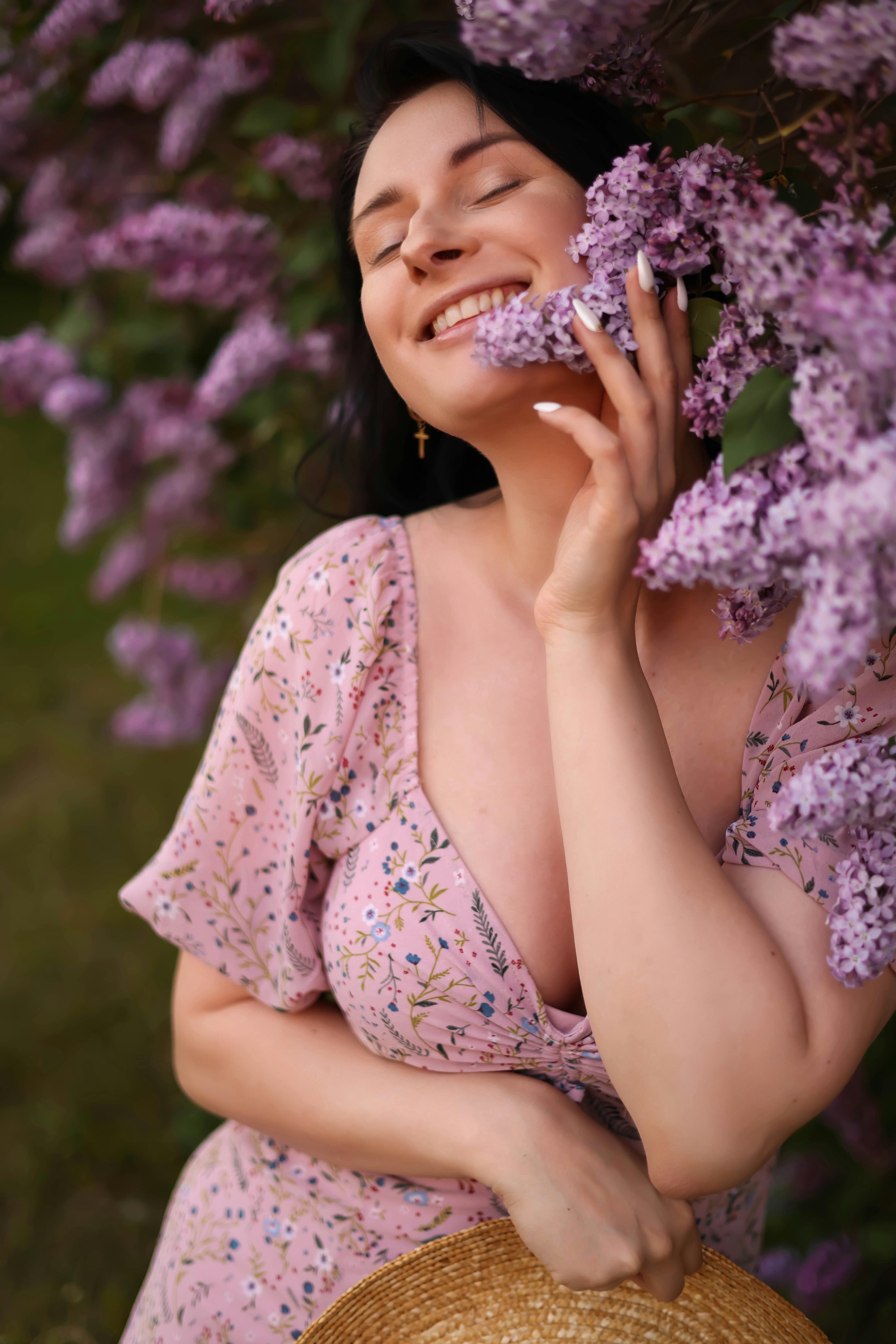 Free Smiling Woman Holding Lilac Flowers Stock Photo