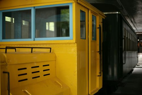 Free A classic yellow subway train exhibited indoors at a transportation museum. Stock Photo
