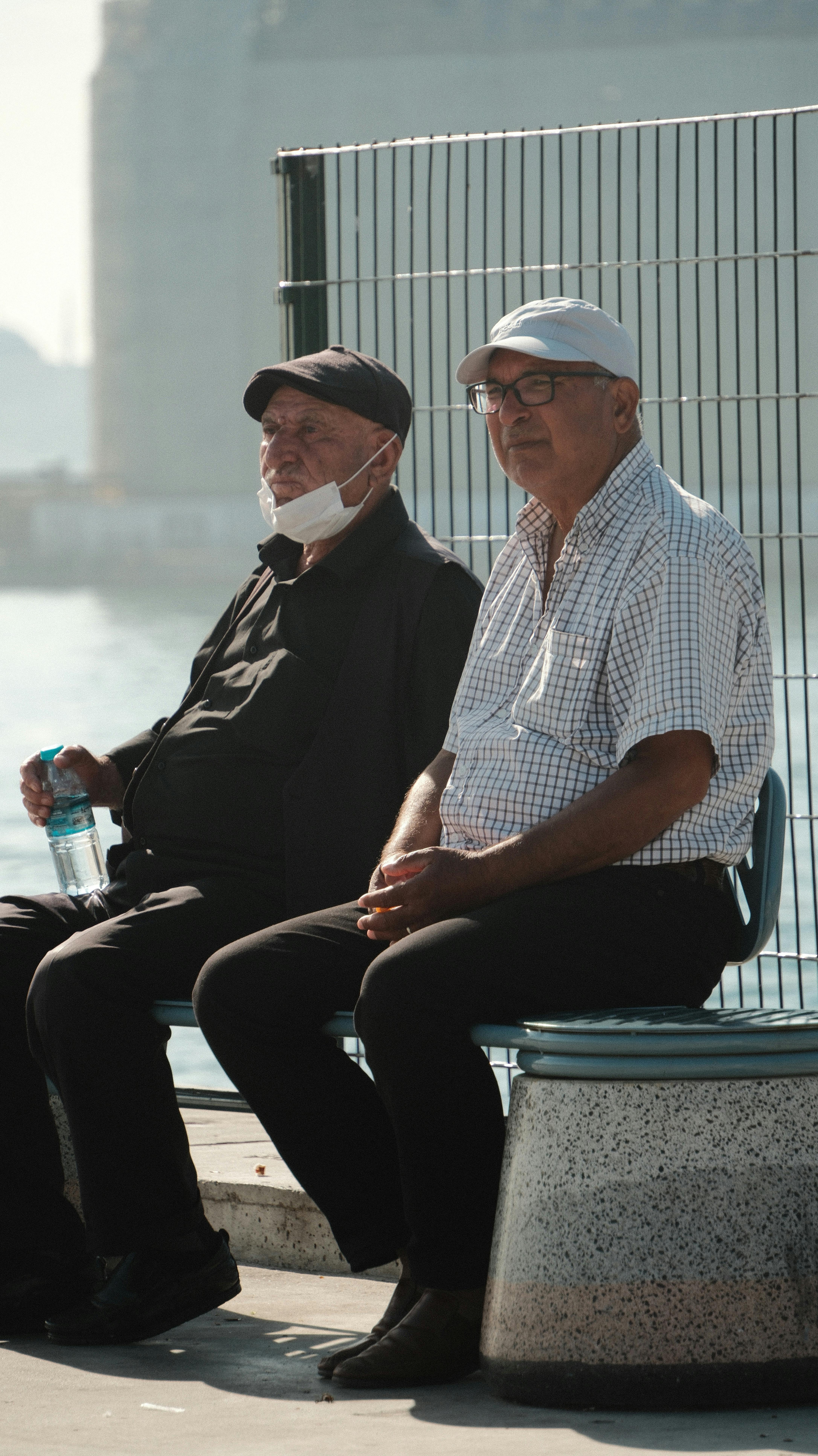 pensioners on bench in harbor