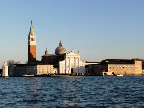 Beautiful view of San Giorgio Maggiore with a clear sky and waterfront in Venice, Italy.