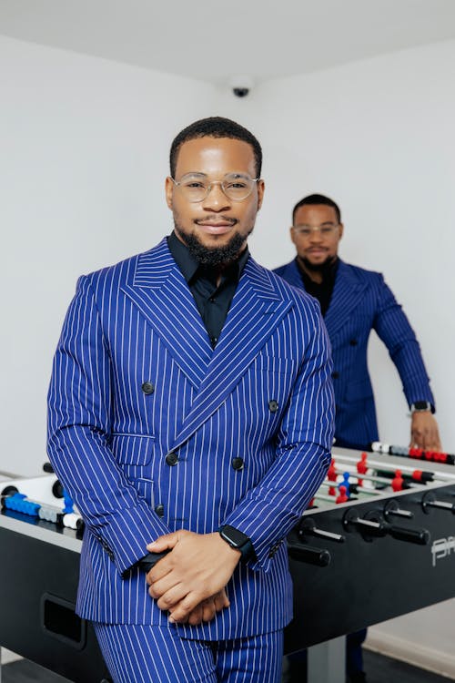 Men Posing by Table Football