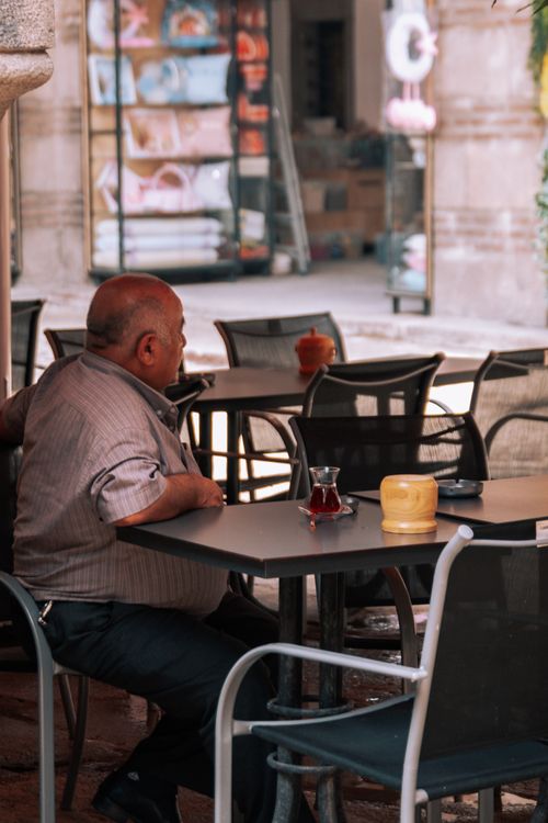 Free An elderly man enjoying tea at an outdoor bistro in Ankara, Türkiye. Stock Photo