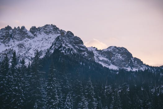 Breathtaking view of snow-capped mountains during twilight with a serene sky.