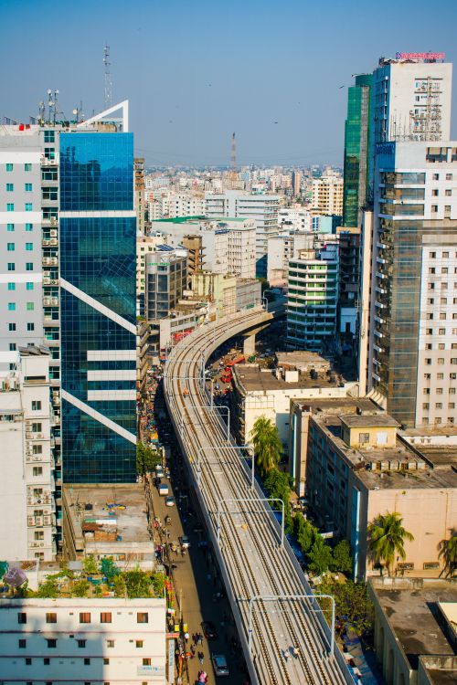 Free Aerial view of a railway cutting through a bustling urban cityscape, surrounded by towering skyscrapers. Stock Photo