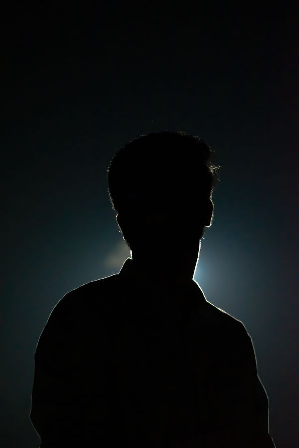 Silhouette of Man in a Dark Room · Free Stock Photo