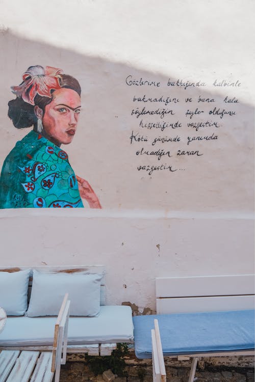 A Mural of a Woman and a Text on the Wall