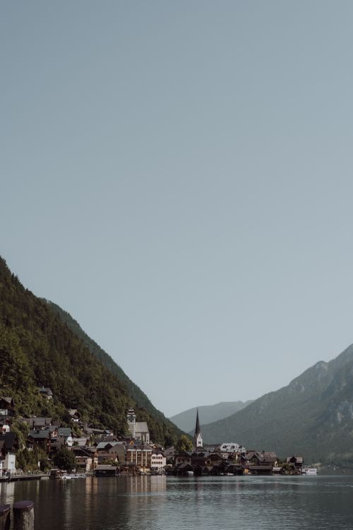 Free Breathtaking view of the picturesque Hallstatt village nestled by a serene lake surrounded by lush mountains. Stock Photo