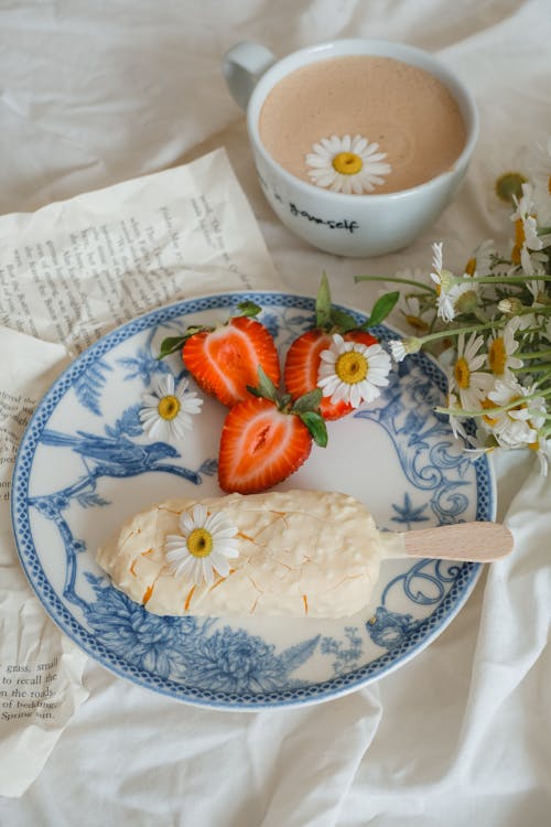 Ice Cream Served on Plate with Strawberries and Chamomile Flowers