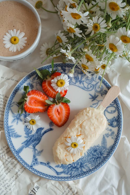 Ice Cream and Strawberries Served with Coffee and Chamomile Flowers