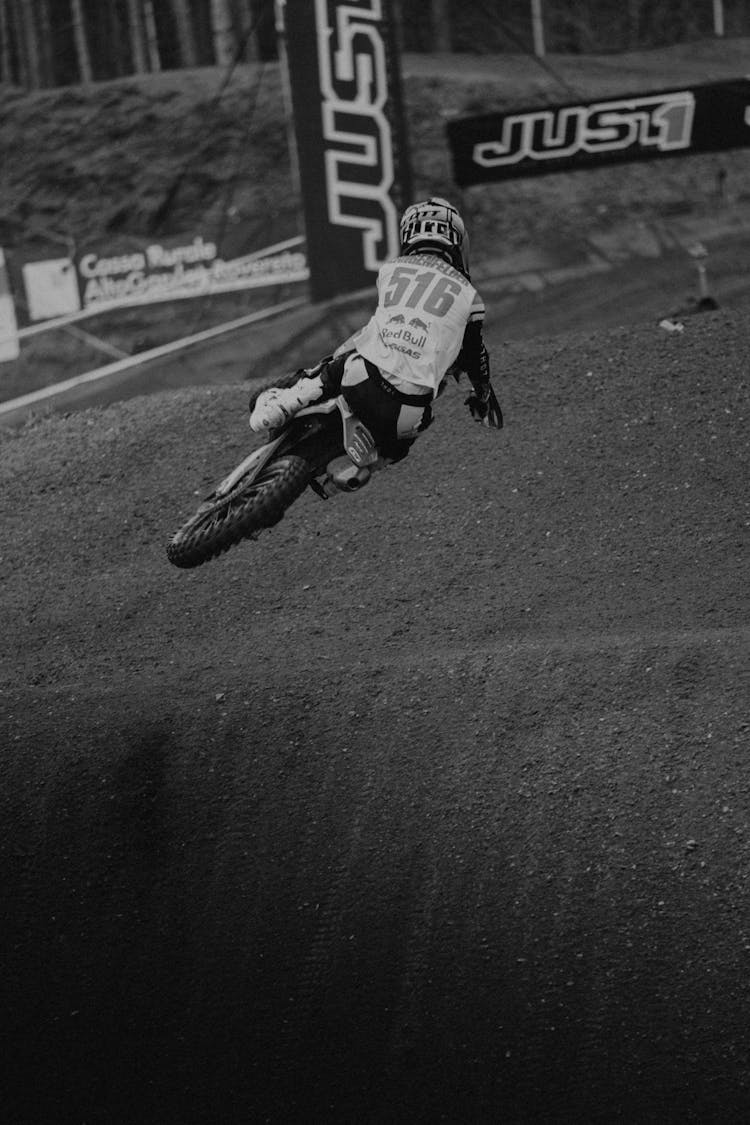 Back View Of Jumping Rider In Motocross Race