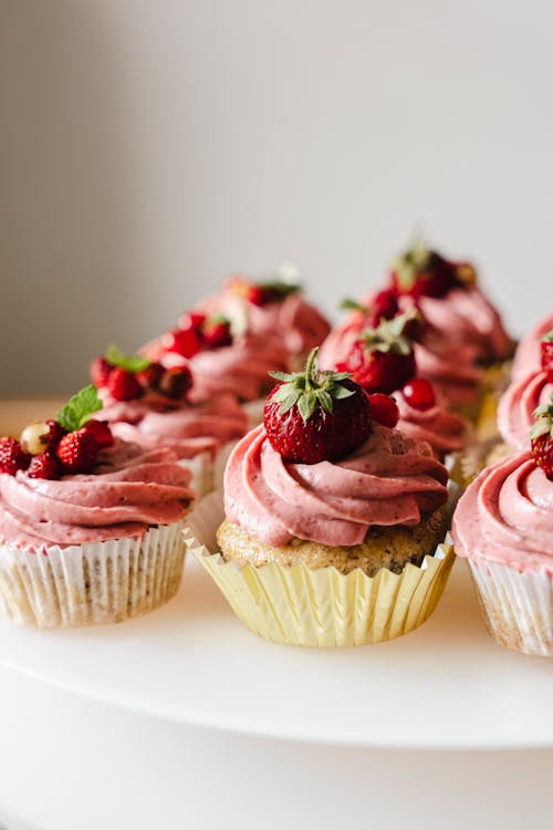 Free Cupcakes with Pink Cream and Fruits Stock Photo