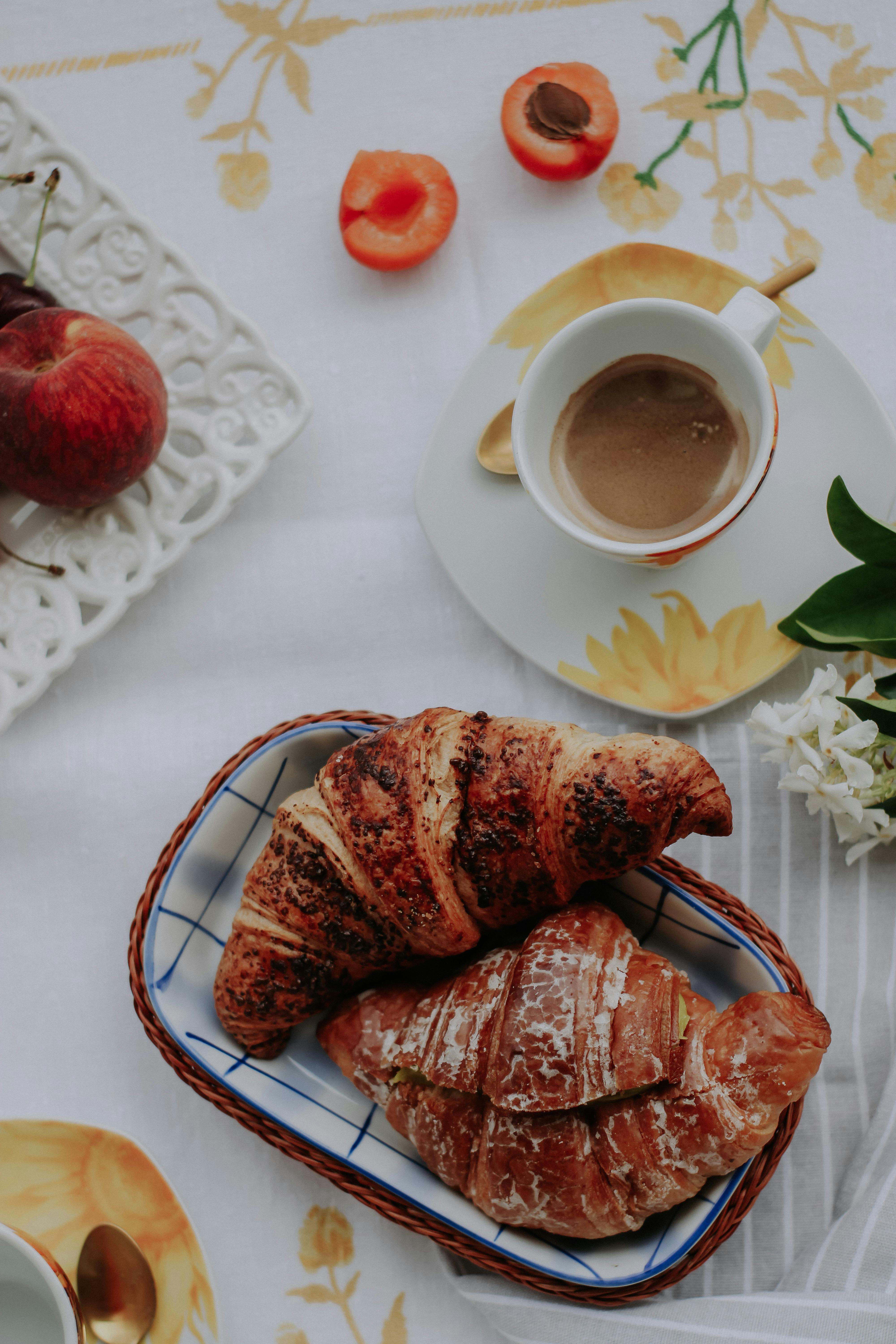 A delightful breakfast table with croissants and coffee, perfect for a cozy morning.