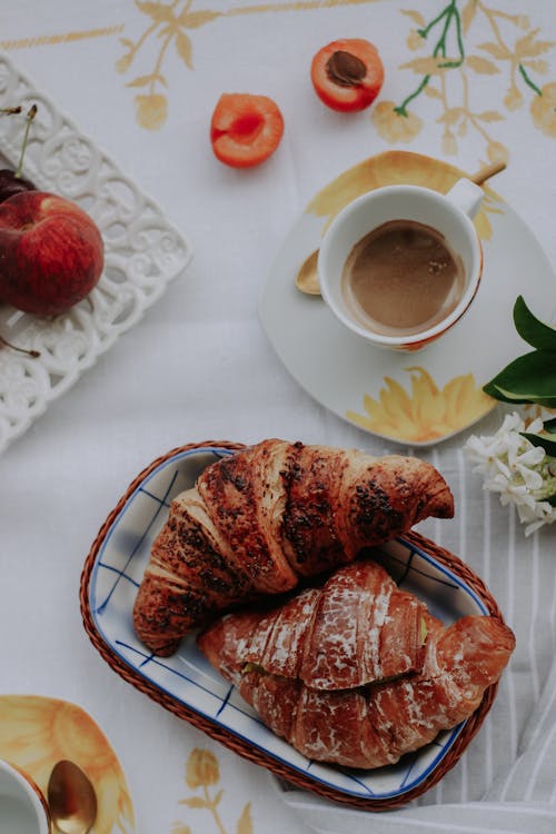 Free Croissants and a Cup of Coffee on the Table  Stock Photo