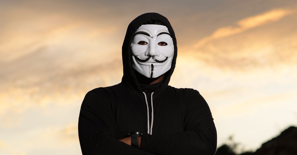 Guy With Mask Man in Guy Fawkes Mask Standing with Arms Crossed · Free Stock Photo