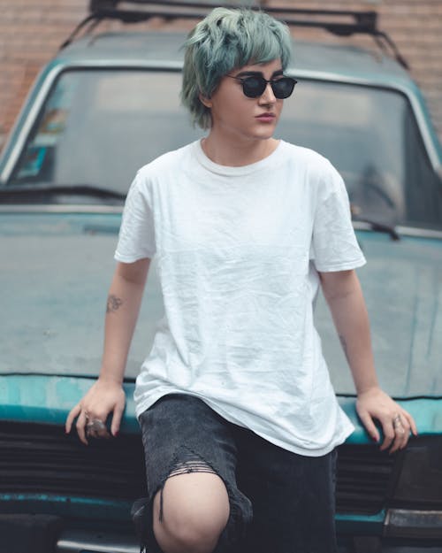 Portrait of Woman in T-shirt, Sunglasses and with Dyed Hair