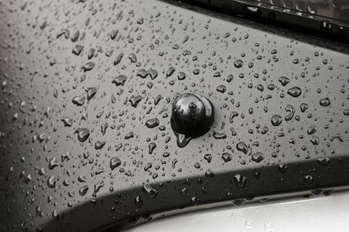 Free Detailed view of raindrops on a sleek metallic car surface, showcasing texture and shine. Stock Photo